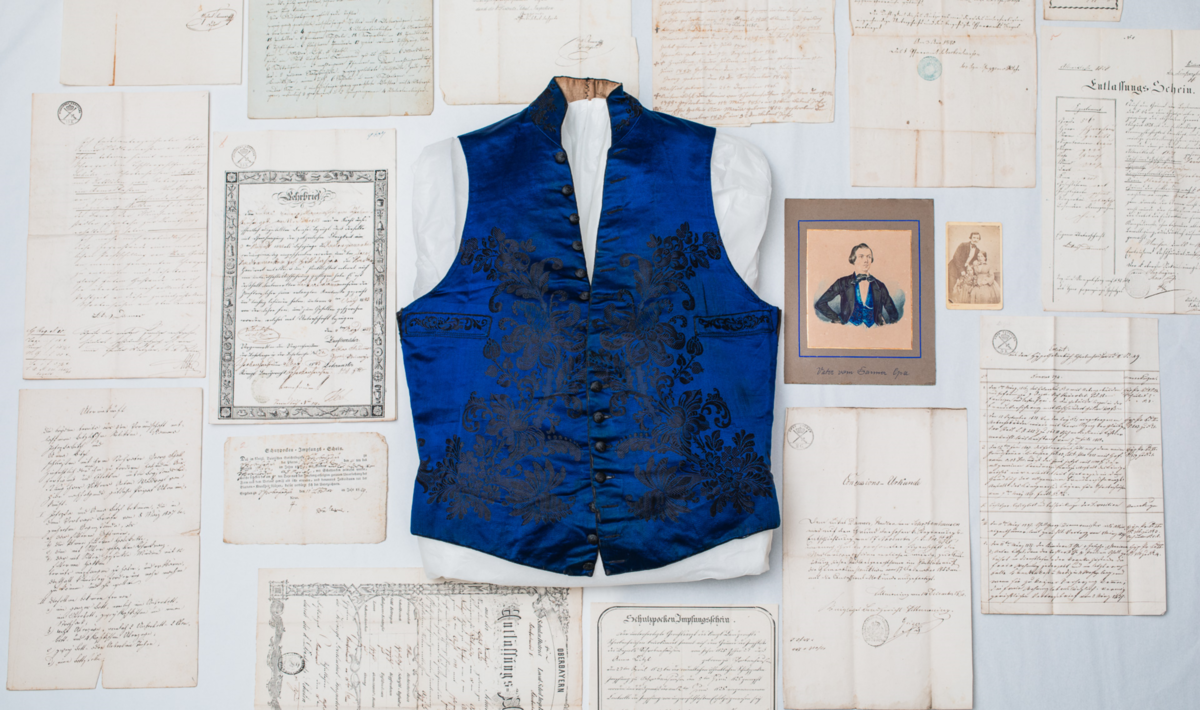 In addition to his blue waistcoat, the Lukas Danner collection includes his birth certificate with baptismal certificate, school reports, vaccination certificates, the "concession deed", inventories of his estate, and Danner's apprenticeship certificate for the needle trade, dated 1843.
