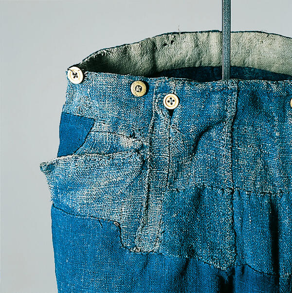 Detail of indigo dyed linen trousers, which has been patched several times. These working trousers are dated about 1850 and originate from Munich.